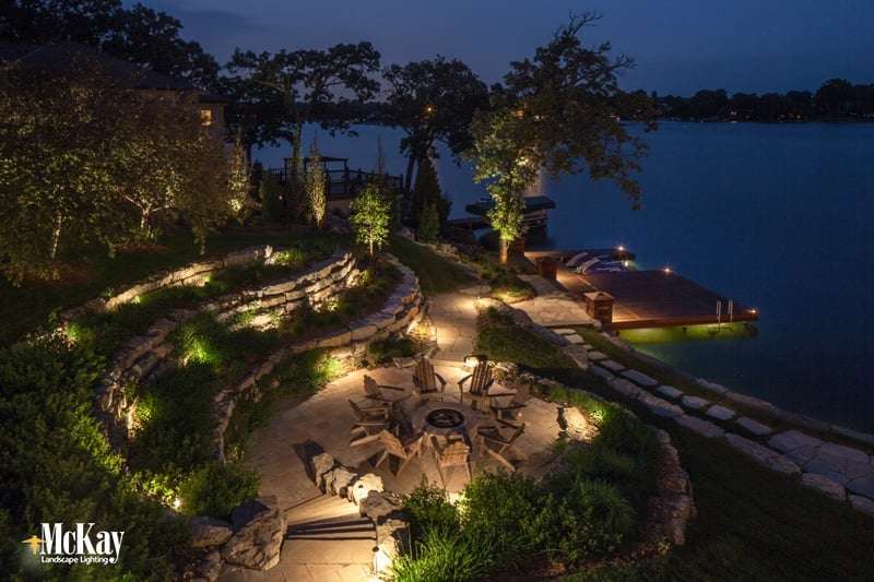 This lake home located in Beaver Lake, Nebraska utilizes several different lighting techniques to illuminate the outdoor fire pit area, dock, and seawall. Click to see more lake home lighitng ideas... | McKay Landscape Lighting, Omaha Nebraska This lake home located in Beaver Lake, Nebraska utilizes several different lighting techniques to illuminate the outdoor fire pit area, dock, and seawall. Click to see more lake home lighitng ideas... | McKay Landscape Lighting, Omaha Nebraska