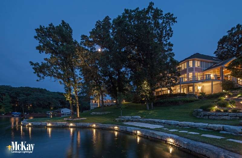 This lake home located in Beaver Lake, Nebraska utilizes several different lighting techniques to illuminate the outdoor fire pit area, dock, and seawall. Click to see more lake home lighitng ideas... | McKay Landscape Lighting, Omaha Nebraska This lake home located in Beaver Lake, Nebraska utilizes several different lighting techniques to illuminate the outdoor fire pit area, dock, and seawall. Click to see more lake home lighitng ideas... | McKay Landscape Lighting, Omaha Nebraska